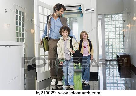 Stock Photo - Man with his children entering a house. Fotosearch
