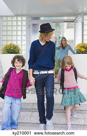 Woman waving goodbye to her children View Large Photo Image Stock Image - Woman waving goodbye to her children. Fotosearch