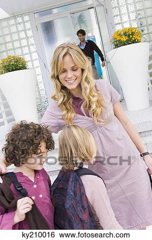 Woman with her children leaving for school View Large Photo Image Stock Photograph - Woman with her children leaving for school. Fotosearch
