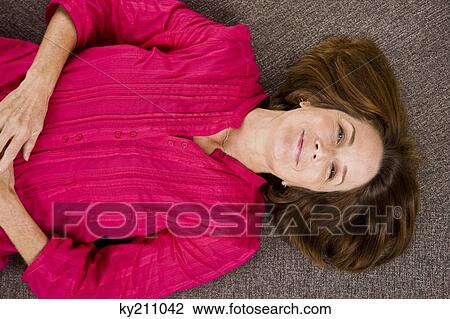 Close-up of a woman lying on mattress View Large Photo Image Stock Image - Close-up of a woman lying on mattress. Fotosearch
