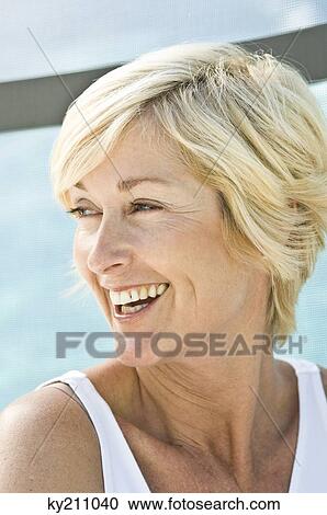 Close-up of a woman smiling View Large Photo Image Stock Image - Close-up of a woman smiling. Fotosearch