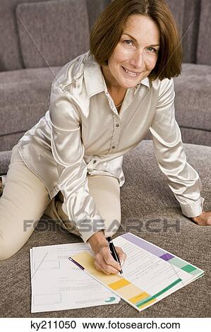 Woman filling out an application form View Large Photo Image Stock Image - Woman filling out an application form. Fotosearch