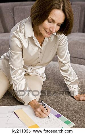 Woman filling out an application form View Large Photo Image Stock Photography - Woman filling out an application form. Fotosearch