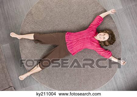 Woman lying on a round sofa View Large Photo Image Picture - Woman lying on a round sofa. Fotosearch