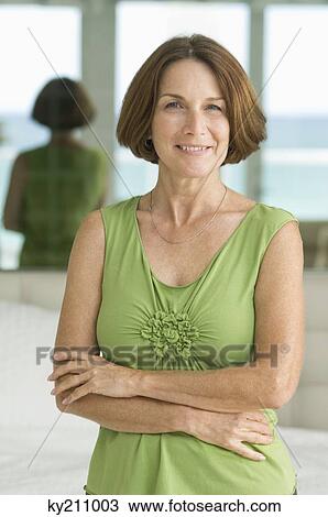 Woman standing with her arms crossed View Large Photo Image Stock Image - Woman standing with her arms crossed. Fotosearch