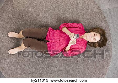 Woman text messaging on a mobile phone View Large Photo Image Stock Photography - Woman text messaging on a mobile phone. Fotosearch