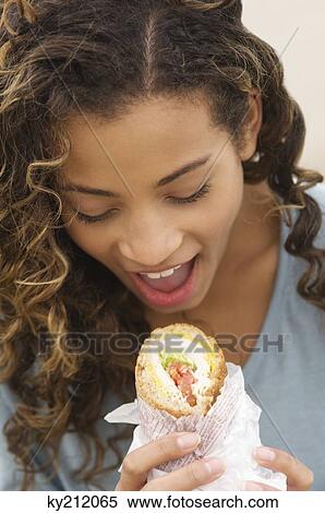 Close-up of a girl eating a sandwich View Large Photo Image Stock Photography - Close-up of a girl eating a sandwich. Fotosearch