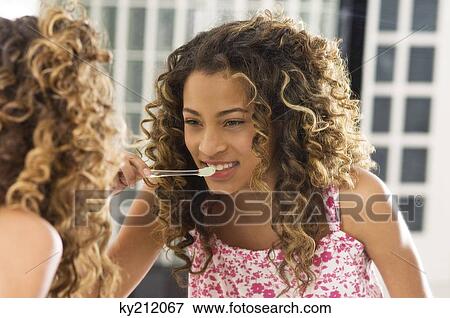 Girl brushing her teeth View Large Photo Image Stock Photo - Girl brushing her teeth. Fotosearch