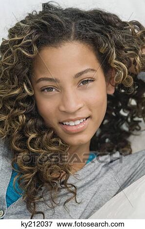 Girl lying on the bed and smiling View Large Photo Image Stock Photo - Girl lying on the bed and smiling. Fotosearch