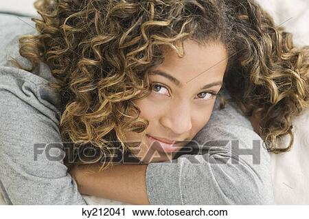 Girl lying on the bed and smirking View Large Photo Image Stock Image - Girl lying on the bed and smirking. Fotosearch