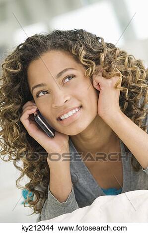 Girl talking on a mobile phone View Large Photo Image Picture - Girl talking on a mobile phone. Fotosearch
