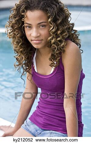 Portrait of a girl sitting at the poolside View Large Photo Image Stock Image - Portrait of a girl sitting at the poolside. Fotosearch