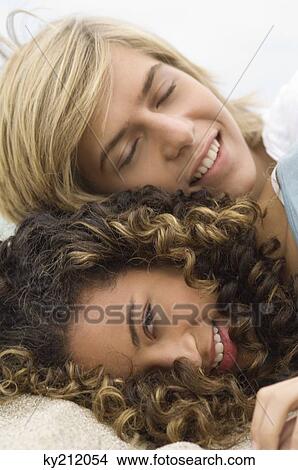 Teenage boy and a girl relaxing on the beach View Large Photo Image Picture - Teenage boy and a girl relaxing on the beach. Fotosearch