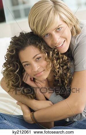 Teenage boy embracing a girl from behind View Large Photo Image Stock Image - Teenage boy embracing a girl from behind. Fotosearch