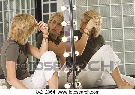 Teenage boy looking at himself in a mirror View Large Photo Image Picture - Teenage boy looking at himself in a mirror. Fotosearch