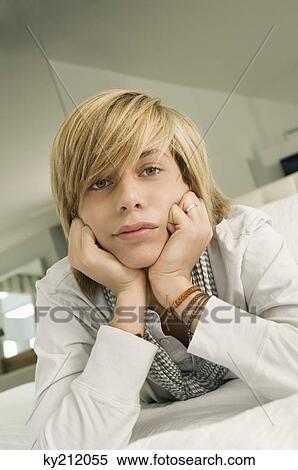 Teenage boy lying on the bed View Large Photo Image Stock Photography - Teenage boy lying on the bed. Fotosearch
