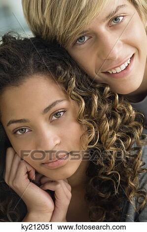 Teenage boy smiling with a girl View Large Photo Image Stock Image - Teenage boy smiling with a girl. Fotosearch