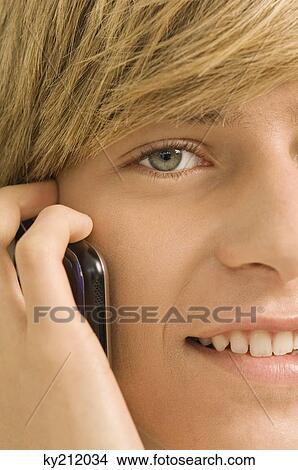 Teenage boy talking on a mobile phone View Large Photo Image Picture - Teenage boy talking on a mobile phone. Fotosearch