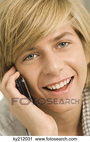 Teenage boy talking on a mobile phone View Large Photo Image Stock Image - Teenage boy talking on a mobile phone. Fotosearch