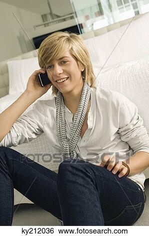 Stock Photograph - Teenage boy talking on a mobile phone. Fotosearch