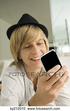Teenage boy using a mobile phone View Large Photo Image Stock Image - Teenage boy using a mobile phone. Fotosearch