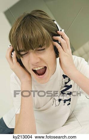 Picture - Boy listening to headphones. Fotosearch