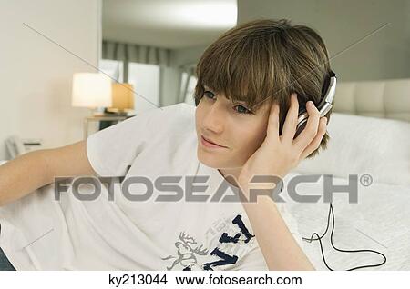 Boy listening to headphones View Large Photo Image Picture - Boy listening to headphones. Fotosearch