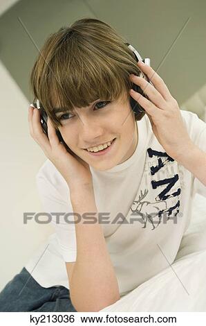 Boy listening to headphones View Large Photo Image Stock Photograph - Boy listening to headphones. Fotosearch