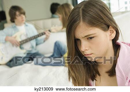 Close-up of a girl looking upset View Large Photo Image Stock Photo - Close-up of a girl looking upset. Fotosearch
