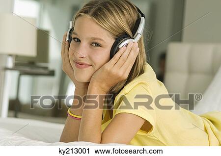 Girl listening to headphones View Large Photo Image Stock Image - Girl listening to headphones. Fotosearch