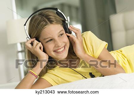 Girl listening to headphones View Large Photo Image Stock Image - Girl listening to headphones. Fotosearch