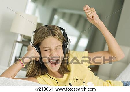 Girl listening to headphones View Large Photo Image Stock Image - Girl listening to headphones. Fotosearch