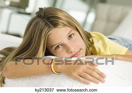 Stock Photo - Girl lying on the bed. Fotosearch