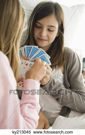 Two girls playing cards View Large Photo Image Stock Photography - Two girls playing cards. Fotosearch