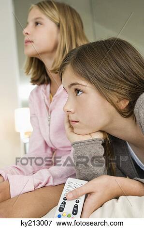 Stock Photo - Two girls watching television. Fotosearch
