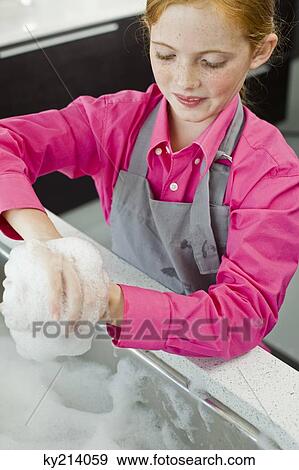 Close-up of a girl washing her hands at a sink View Large Photo Image Stock Photo - Close-up of a girl washing her hands at a sink. Fotosearch