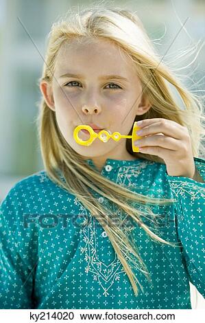 Girl blowing soap bubbles with a bubble wand View Large Photo Image Stock Image - Girl blowing soap bubbles with a bubble wand. Fotosearch