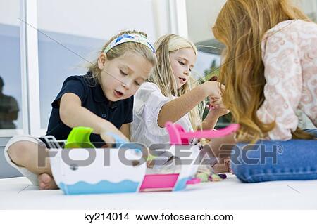 Three girls playing with toys View Large Photo Image Picture - Three girls playing with toys. Fotosearch