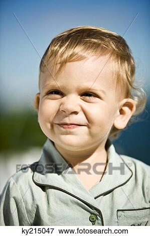 Close-up of a baby boy grinning View Large Photo Image Stock Photo - Close-up of a baby boy grinning. Fotosearch