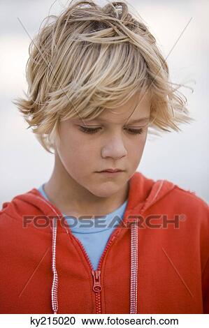 Stock Image - Close-up of a boy thinking. Fotosearch