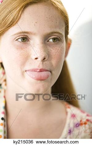 Stock Photograph - Close-up of a girl sticking her tongue out. Fotosearch
