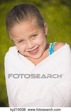 Portrait of a girl wrapped in a towel and smiling View Large Photo Image Stock Photo - Portrait of a girl wrapped in a towel and smiling. Fotosearch