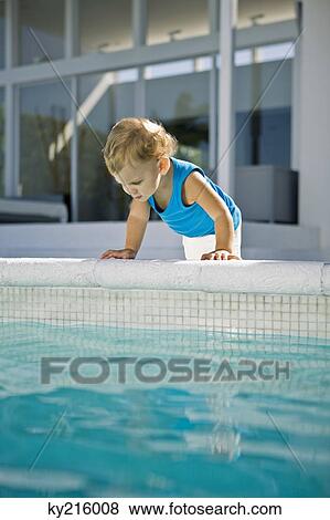 Baby boy looking into a swimming pool View Large Photo Image Stock Photo - Baby boy looking into a swimming pool. Fotosearch