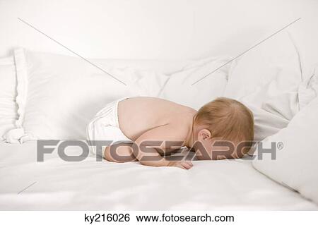 Baby girl crying on the bed View Large Photo Image Stock Photograph - Baby girl crying on the bed. Fotosearch