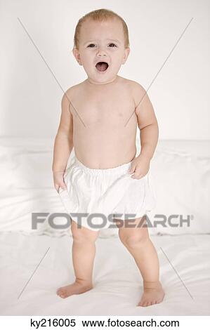 Stock Photography - Baby girl crying on the bed. Fotosearch