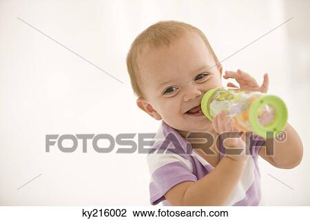 Baby girl drinking water from a baby bottle View Large Photo Image Stock Image - Baby girl drinking water from a baby bottle. Fotosearch