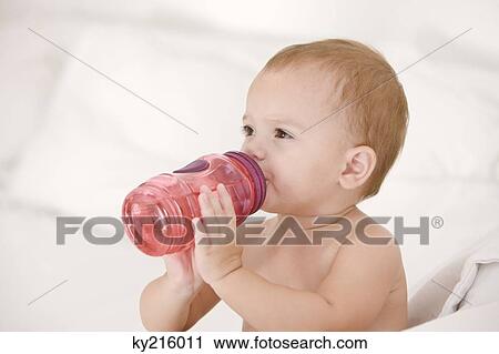 Baby girl drinking water from a baby bottle View Large Photo Image Stock Image - Baby girl drinking water from a baby bottle. Fotosearch