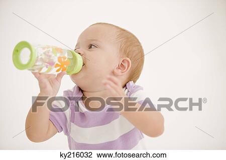Baby girl drinking water from a baby bottle View Large Photo Image Stock Image - Baby girl drinking water from a baby bottle. Fotosearch