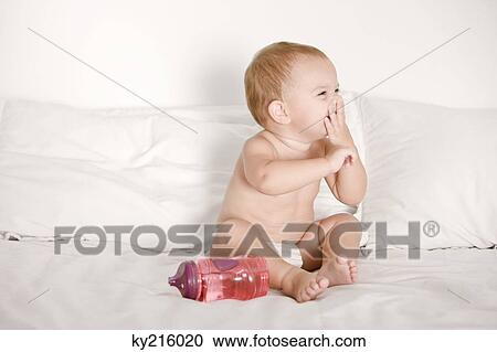 Baby girl laughing on the bed View Large Photo Image Stock Image - Baby girl laughing on the bed. Fotosearch