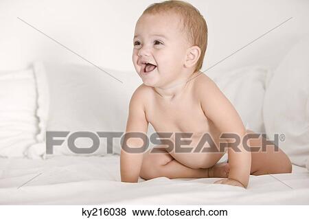 Baby girl laughing on the bed View Large Photo Image Stock Photo - Baby girl laughing on the bed. Fotosearch